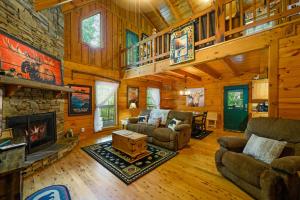 a living room with a fireplace in a log cabin at GYPSY ROAD - Privacy! Log Cabin with Hot Tub, WiFi, DirecTV and Arcade in Sevierville