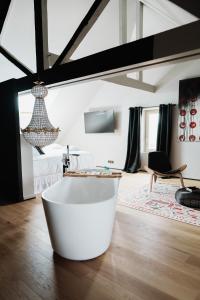 a large white bath tub sitting in a room at Maison Durieux in Limoges