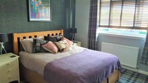 Un pat sau paturi într-o cameră la Holiday Apartment, Balloch, Loch Lomond