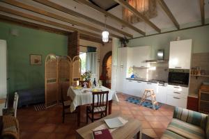 a living room with a table and a kitchen at Holiday Maison Villa Arci in Giardini Naxos