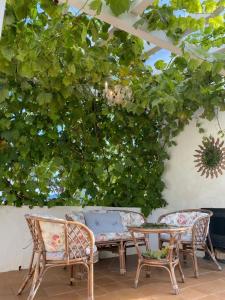 a patio with a table and chairs and a bench at El Rincón de El Montán in Avilés +14 photos