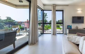 a living room with a couch and a large window at Paradiso Luxury Apartment, Rovinj in Rovinj