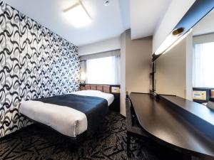 a hotel room with a bed and a desk at APA Hotel Kintetsu-Nara Ekimae in Nara