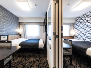 Postel nebo postele na pokoji v ubytování APA Hotel Kintetsu Nara Ekimae