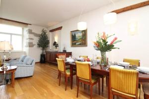 a living room with a dining room table and chairs at Tallinn City Apartments - Luxury 3 bedroom, sauna, views in Tallinn