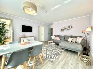 a living room with a table and a couch at Apartment Rooftop - Dresden trifft Sächsische Schweiz! in Dresden
