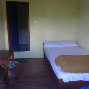 En eller flere senge i et værelse på Begnas Coffee House & Hotel
