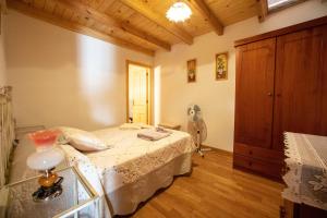 a bedroom with a bed and a fan at El Capricho in Villamiel