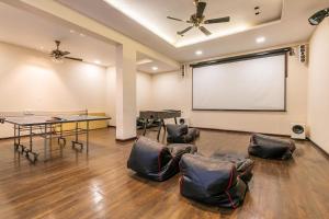 a meeting room with a projector screen and chairs at Arihant Villa by StayVista - 5BHK Luxurious Villa with Pvt Pool in Lonavala +30 photos