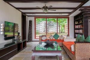 a living room with a couch and a table at Arihant Villa by StayVista - 5BHK Luxurious Villa with Pvt Pool in Lonavala