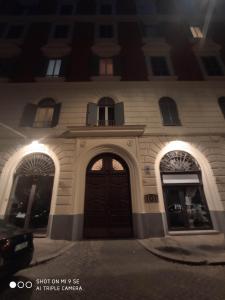 a building with a brown door and windows at night at Double B Ferruccio I in Rome