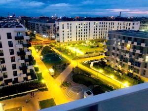 a view of a city at night with buildings at Apartament z tarasem i widokiem na Odrę in Wrocław +37 photos