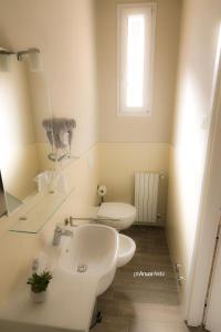 a white bathroom with a sink and a toilet at Le Stanze in Bologna