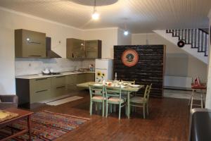 a kitchen and dining room with a table and chairs at Gabala Explorers' Villa near Tufandag in Gabala