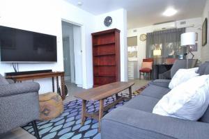 a living room with a couch and a tv at LOCATION LIFESTYLE CONVENIENCE! WIFI NETFLIX WINE in Perth