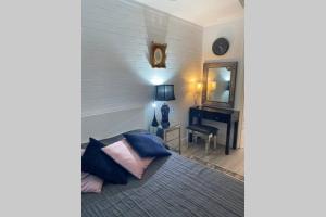 a bedroom with a bed and a mirror and a desk at LOCATION LIFESTYLE CONVENIENCE! WIFI NETFLIX WINE in Perth