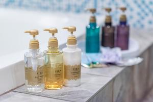 a row of bottles sitting on a counter in a bathroom at Hotel Blanc Chapel Christmas Sakai (Adult Only) in Sakai