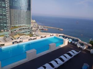 a swimming pool with a view of the ocean at Haeundae Central Hotel in Busan