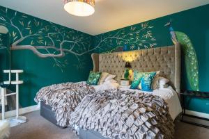 阿伯里斯特威斯Maes Bach Boutique GUEST HOUSE TOWN CENTRE的卧室配有一张带树壁画的床