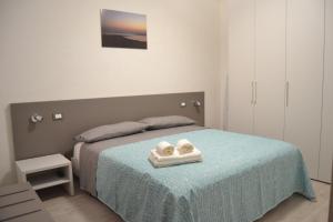 a bedroom with a bed with two towels on it at Il Birillo Casa Vacanze in Trapani