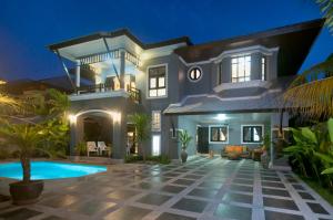 a villa with a swimming pool at night at Baan Santhiya Private Pool Villas - Free Tuk-Tuk Service to the Beach! in Ao Nang Beach