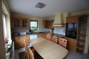 a kitchen with a wooden table in a kitchen at Rötenbacher Wiesen in Friedenweiler
