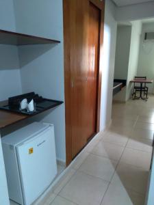 a kitchen with a counter and a dishwasher in a room at Virgilius Palace Hotel in Araxá