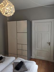 a bedroom with two beds and a white door at Altstadtbummel in Flensburg