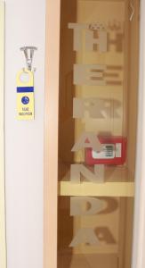 een glazen deur met een nieuw bord erop bij Theranda Boutique Hotel in Tirana