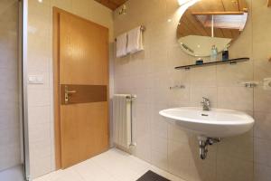a bathroom with a sink and a mirror at Villa Resi Apartments in Corvara in Badia