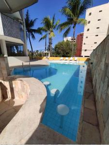 una gran piscina con azulejos azules alrededor. en victory flat em Intermares, en Cabedelo