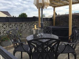 an outdoor table with two chairs and an umbrella at bwthyn y porthmyn in Llandovery