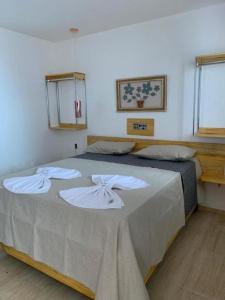 a bedroom with a large bed with towels on it at HOTEL CAJUINA AVENIDA in Teresina