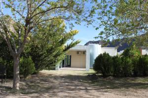 a white house with a tree in front of it at Chalet del Valle Grande in Valle Grande