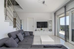 A seating area at VILLA Mari with private pool