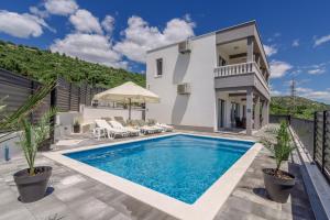 a swimming pool in the backyard of a house at VILLA Mari with private pool in Marina