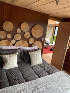 a bedroom with a bunch of logs on the wall at Forel in Toconey