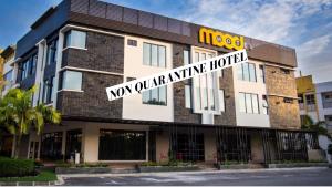 a building with a sign on the front of it at Mood Hotel in Skudai