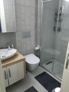 a bathroom with a shower and a toilet and a sink at GUL APART ANTALYA in Aksu