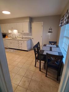 a kitchen with a table and chairs in a room at Andrea Abode home in Lexington +36 photos