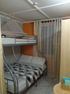 a bunk bed in a room with a window at Elegance & Simplicity in Mombasa