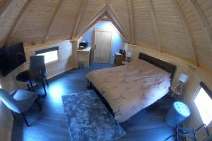 a bedroom with a bed and a desk in a room at Unique luxury cabin 2 in Inverness