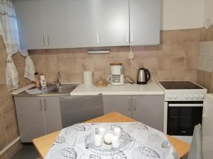 a kitchen with a table with candles on it at Apartment Barbara in Kulen Vakuf