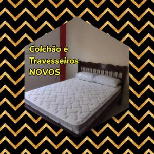 a picture of a bed with a black and white stripes at Casa Camargo 2 - Lugar Aconchegante in Olímpia
