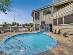 a swimming pool in front of a building at 102 Pointes North Inn in Charlevoix