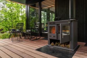 a fireplace on the deck of a house at Het Uilennest in Otterlo