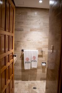 a bathroom with two towels hanging on a wall at Hotel Juarez in Mexico City