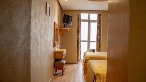 a hotel room with two beds and a window at Hotel Juarez in Mexico City