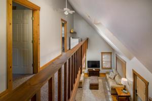 a living room with a staircase with a couch at Blue Spruce . Trailside Lodging in Millersburg