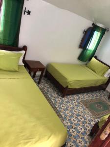 Ένα ή περισσότερα κρεβάτια σε δωμάτιο στο Hotel Nisrine